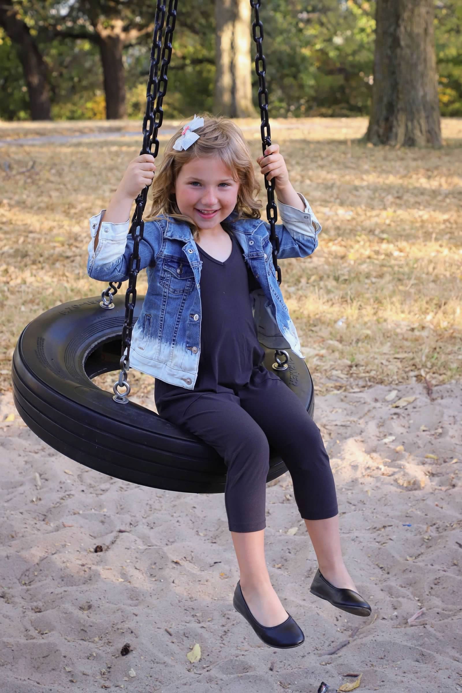 Omaha children's milestone photographer — little girl on swing by Krystal Ann Photography