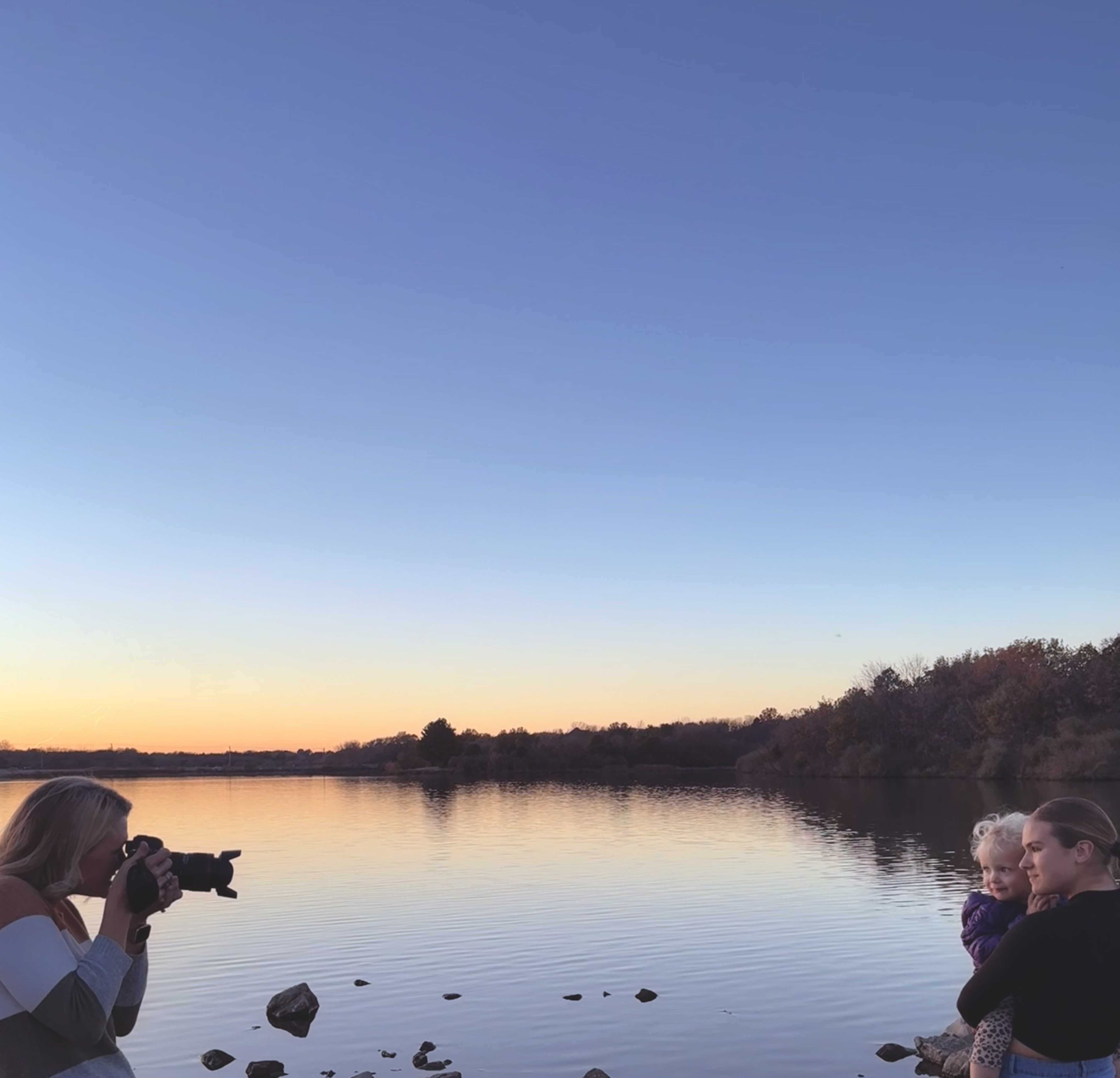 Krystal Ann, Omaha portrait photographer, smiling outdoors with camera